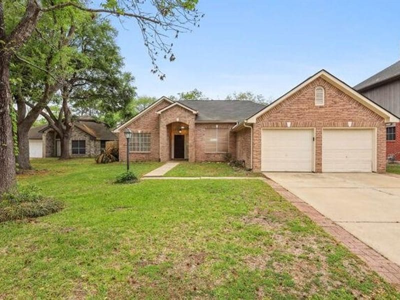 One-story brick home with a two-car garage and a large front lawn
